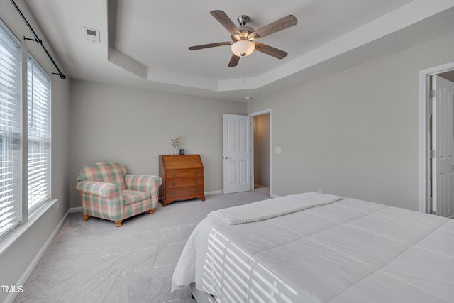 8404 Saltwood Pl, Raleigh, NC 27617 - carpeted bedroom featuring baseboards, a tray ceiling, and a ceiling fan