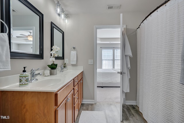 8404 Saltwood Pl, Raleigh, NC 27617 - ensuite bathroom featuring wood finished floors, double vanity, a ceiling fan, and baseboards