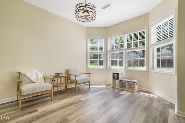 6 Beaver Creek Ln, Durham, NC 27703 - sitting room featuring wood finished floors, baseboards, and a chandelier