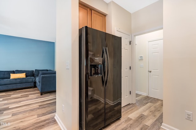 6 Beaver Creek Ln, Durham, NC 27703 - kitchen with black fridge, light wood-type flooring, and baseboards
