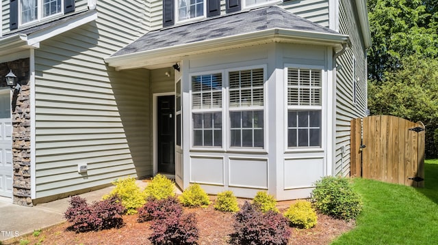 6 Beaver Creek Ln, Durham, NC 27703 - view of exterior entry with a garage and a shingled roof