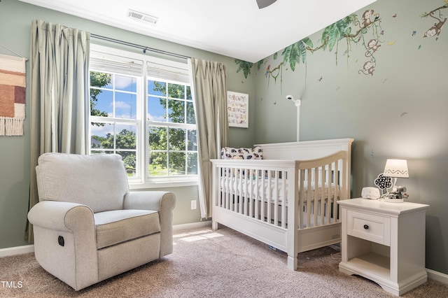 6 Beaver Creek Ln, Durham, NC 27703 - carpeted bedroom featuring a crib and baseboards