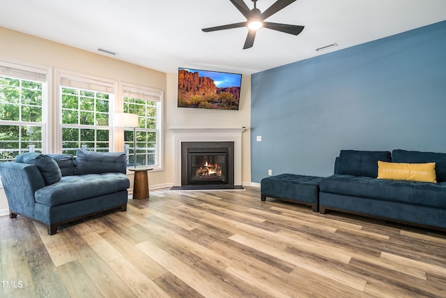 6 Beaver Creek Ln, Durham, NC 27703 - living room featuring ceiling fan, light wood finished floors, a fireplace with flush hearth, and baseboards