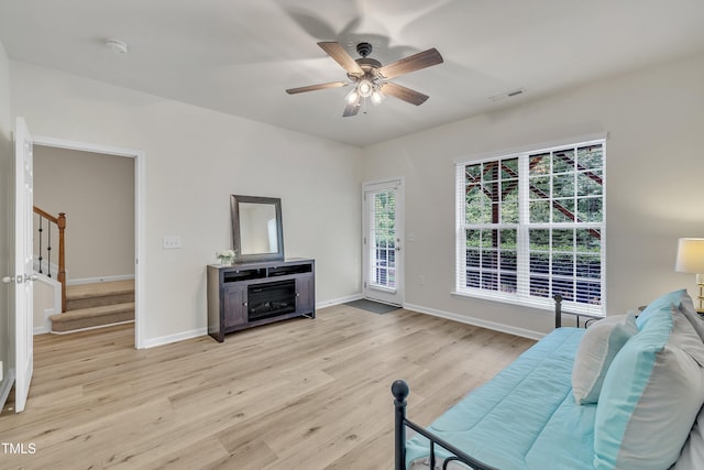 2744 Laurelcherry St, Raleigh, NC 27612 - living room featuring light wood-style flooring, stairway, a ceiling fan, and baseboards
