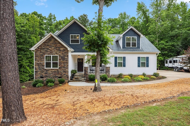100 Lexington Ave, Zebulon, NC 27597 - view of front of property with covered porch, a shingled roof, and crawl space