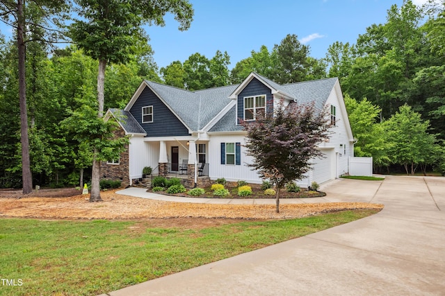100 Lexington Ave, Zebulon, NC 27597 - craftsman house featuring a porch, concrete driveway, an attached garage, and roof with shingles