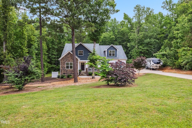 100 Lexington Ave, Zebulon, NC 27597 - view of front of house with stone siding, concrete driveway, and a front lawn
