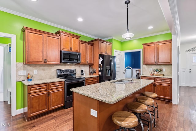 100 Lexington Ave, Zebulon, NC 27597 - kitchen with black fridge with ice dispenser, stainless steel range with electric cooktop, a sink, hardwood / wood-style flooring, and ornamental molding