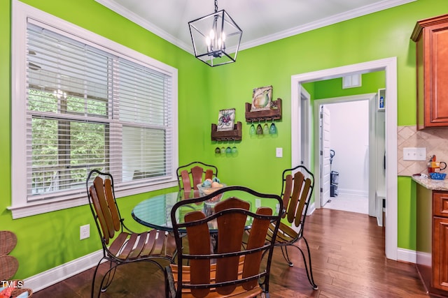 100 Lexington Ave, Zebulon, NC 27597 - dining room featuring a chandelier, crown molding, dark wood finished floors, and baseboards