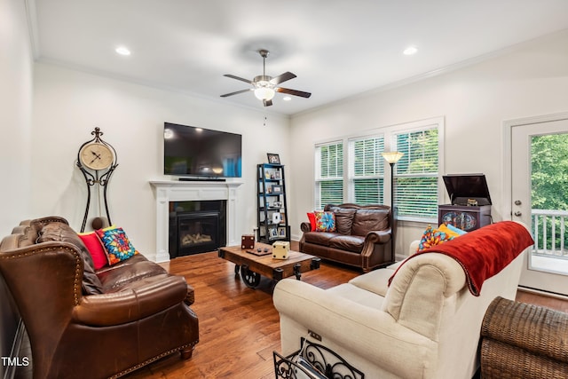 100 Lexington Ave, Zebulon, NC 27597 - living area featuring ceiling fan, wood finished floors, a glass covered fireplace, ornamental molding, and recessed lighting