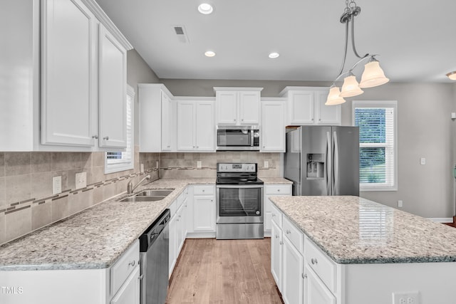 173 Forsyth Pkwy, Clayton, NC 27520 - kitchen featuring appliances with stainless steel finishes, a sink, white cabinetry, and recessed lighting