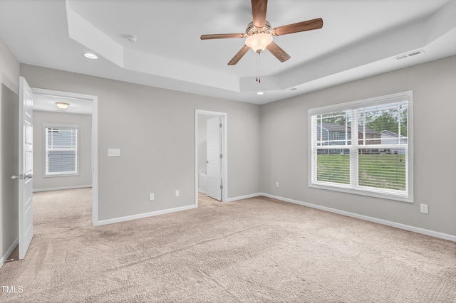 173 Forsyth Pkwy, Clayton, NC 27520 - unfurnished bedroom featuring light carpet, a tray ceiling, baseboards, and recessed lighting
