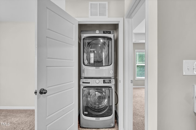 173 Forsyth Pkwy, Clayton, NC 27520 - laundry room featuring carpet, stacked washing machine and dryer, and baseboards