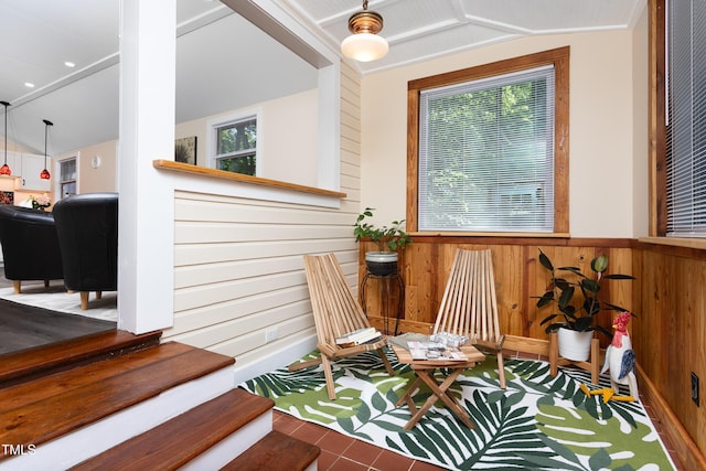 126 Barclay Rd, Chapel Hill, NC 27516 - living area featuring vaulted ceiling, healthy amount of natural light, wooden walls, a wainscoted wall, and tile patterned flooring