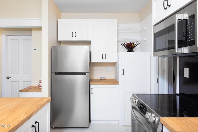 126 Barclay Rd, Chapel Hill, NC 27516 - kitchen with stainless steel appliances, butcher block countertops, white cabinets, and light marble finish floors