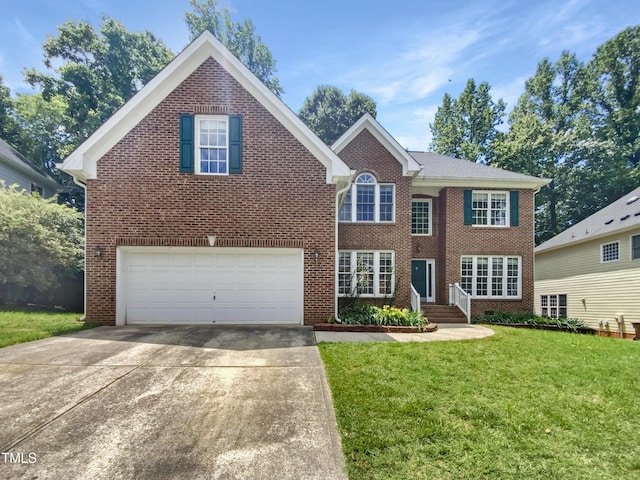 105 Crosswaite Way, Cary, NC 27518 - view of front facade featuring driveway, a garage, brick siding, and a front lawn