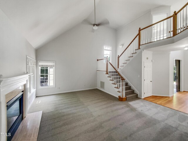 105 Crosswaite Way, Cary, NC 27518 - unfurnished living room with carpet floors, plenty of natural light, high vaulted ceiling, ceiling fan, and stairway