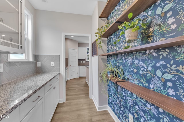 3449 S Beaver Ln, Raleigh, NC 27604 - bar with light wood-style flooring, decorative backsplash, and baseboards