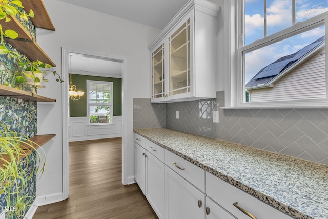 3449 S Beaver Ln, Raleigh, NC 27604 - kitchen with glass insert cabinets, decorative backsplash, dark wood-style floors, white cabinetry, and ornamental molding