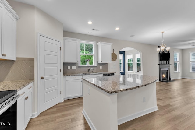 3449 S Beaver Ln, Raleigh, NC 27604 - kitchen with a sink, light wood-style flooring, white cabinetry, a center island, and recessed lighting