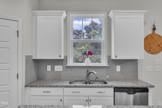 3449 S Beaver Ln, Raleigh, NC 27604 - kitchen featuring stainless steel dishwasher, a sink, white cabinets, and decorative backsplash