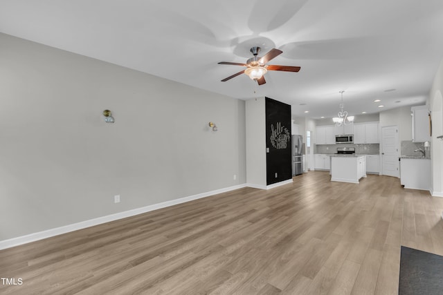 3449 S Beaver Ln, Raleigh, NC 27604 - unfurnished living room featuring a ceiling fan, recessed lighting, a chandelier, light wood-style flooring, and baseboards