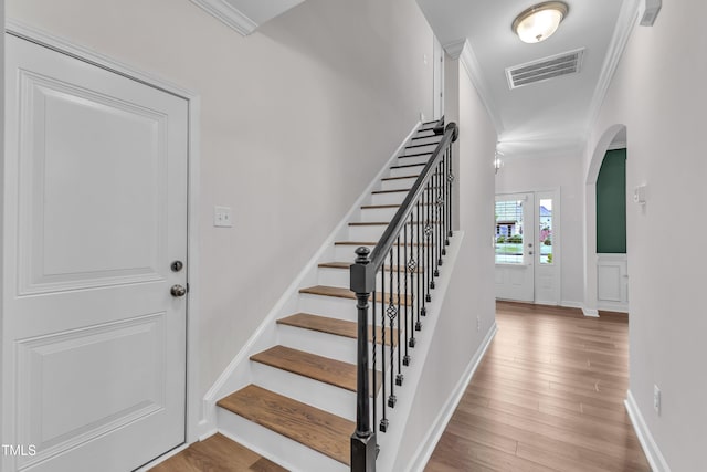 3449 S Beaver Ln, Raleigh, NC 27604 - stairs featuring ornamental molding, arched walkways, wood finished floors, and baseboards