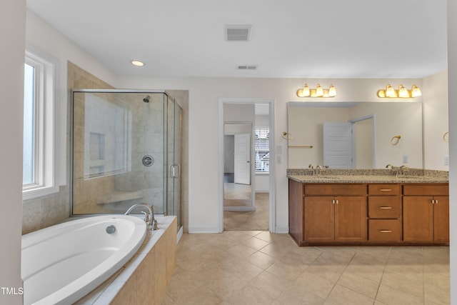 3449 S Beaver Ln, Raleigh, NC 27604 - bathroom with a garden tub, double vanity, healthy amount of natural light, a stall shower, and recessed lighting