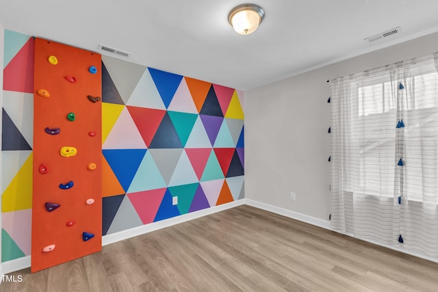 3449 S Beaver Ln, Raleigh, NC 27604 - empty room featuring an accent wall, wood finished floors, and baseboards
