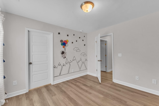 3449 S Beaver Ln, Raleigh, NC 27604 - unfurnished bedroom with light wood-type flooring and baseboards