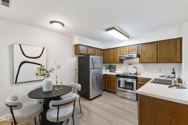 407 Gooseneck Dr Unit B1, Cary, NC 27513 - kitchen featuring stainless steel appliances, under cabinet range hood, light wood-type flooring, and light countertops