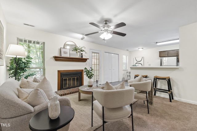 407 Gooseneck Dr Unit B1, Cary, NC 27513 - living room featuring a brick fireplace, plenty of natural light, a ceiling fan, and light carpet