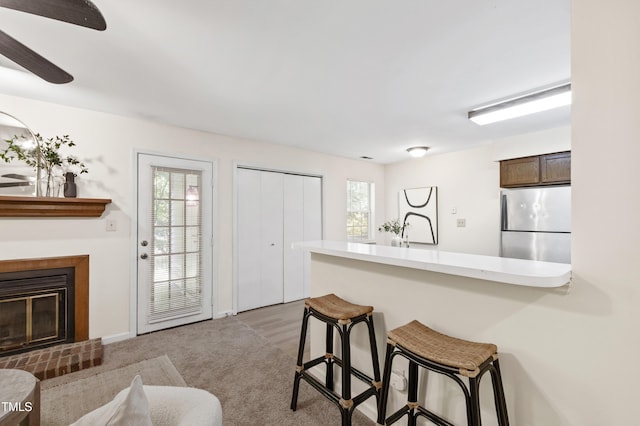 407 Gooseneck Dr Unit B1, Cary, NC 27513 - kitchen featuring freestanding refrigerator, a kitchen breakfast bar, a peninsula, and plenty of natural light