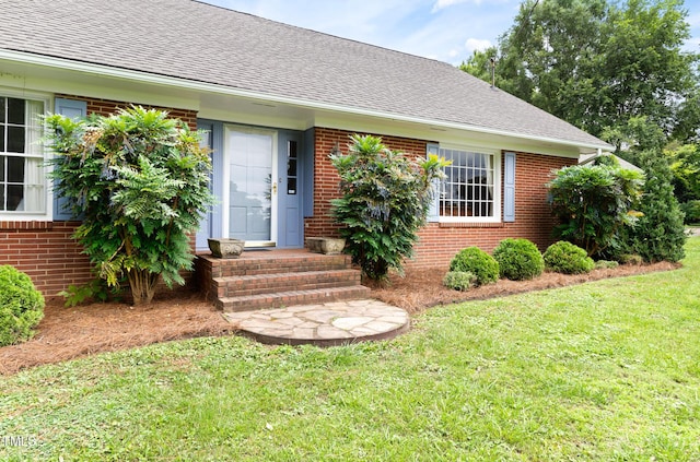816 Miller Rd, Hillsborough, NC 27278 - property entrance with brick siding, a lawn, and a shingled roof
