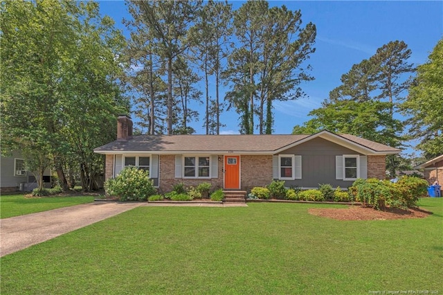 638 E Raynor Dr, Fayetteville, NC 28311 - ranch-style house with a chimney, a front lawn, and brick siding