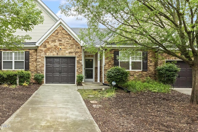 309 Plank Bridge Way, Morrisville, NC 27560 - view of front facade with concrete driveway, stone siding, a shingled roof, and an attached garage