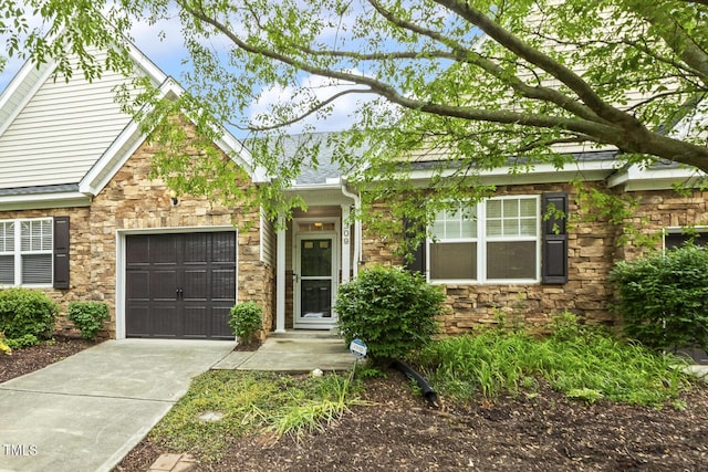 309 Plank Bridge Way, Morrisville, NC 27560 - view of front of house with stone siding, an attached garage, and driveway