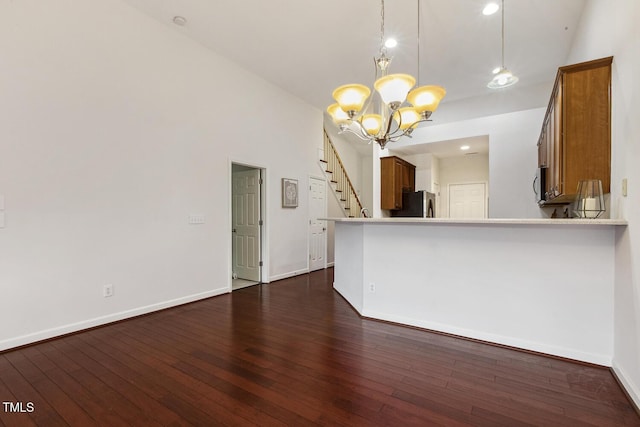 309 Plank Bridge Way, Morrisville, NC 27560 - unfurnished living room featuring a chandelier, dark wood-style flooring, stairway, and baseboards