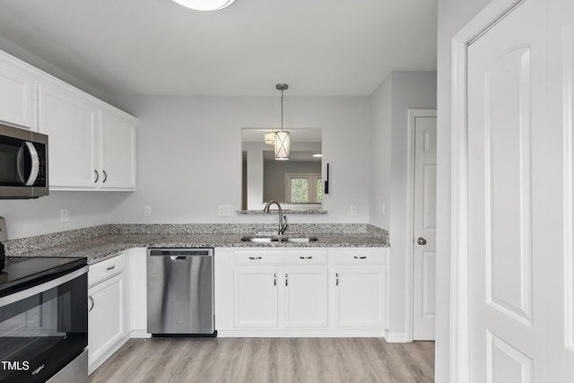 5408 Gunnette Dr, Raleigh, NC 27610 - kitchen featuring appliances with stainless steel finishes, a sink, light wood-style floors, and white cabinets