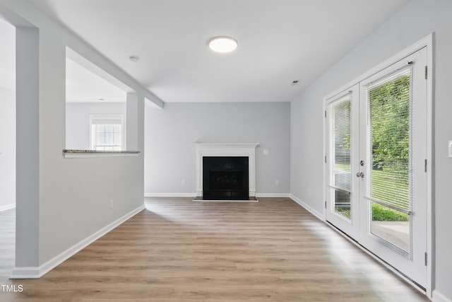 5408 Gunnette Dr, Raleigh, NC 27610 - unfurnished living room with light wood-style floors, baseboards, and a fireplace with flush hearth