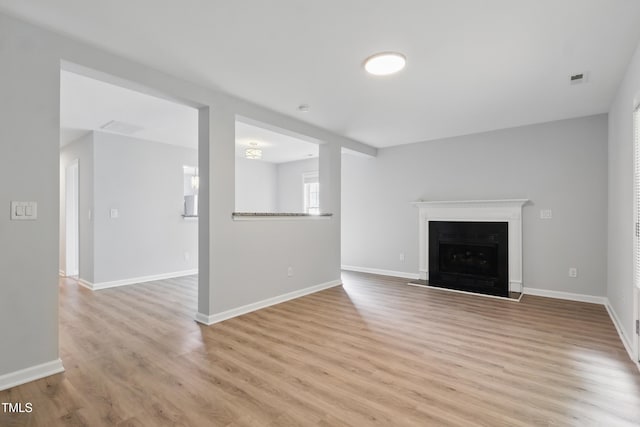 5408 Gunnette Dr, Raleigh, NC 27610 - unfurnished living room with light wood-type flooring, a fireplace, and baseboards