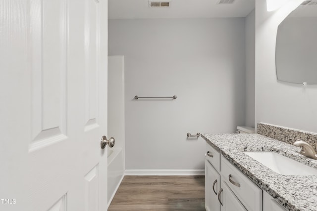 5408 Gunnette Dr, Raleigh, NC 27610 - bathroom with vanity, wood finished floors, and baseboards