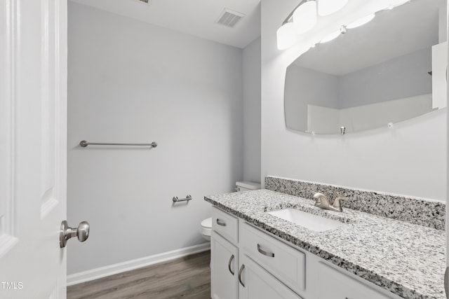 5408 Gunnette Dr, Raleigh, NC 27610 - bathroom with vanity, wood finished floors, toilet, and baseboards