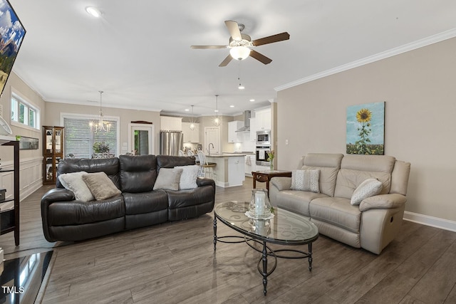 1374 Patriot Points Way, Fuquay Varina, NC 27526 - living area featuring a ceiling fan, wood finished floors, a chandelier, crown molding, and recessed lighting
