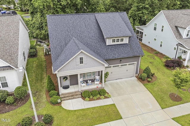 1374 Patriot Points Way, Fuquay Varina, NC 27526 - view of front facade with a porch, a shingled roof, a front yard, a garage, and driveway