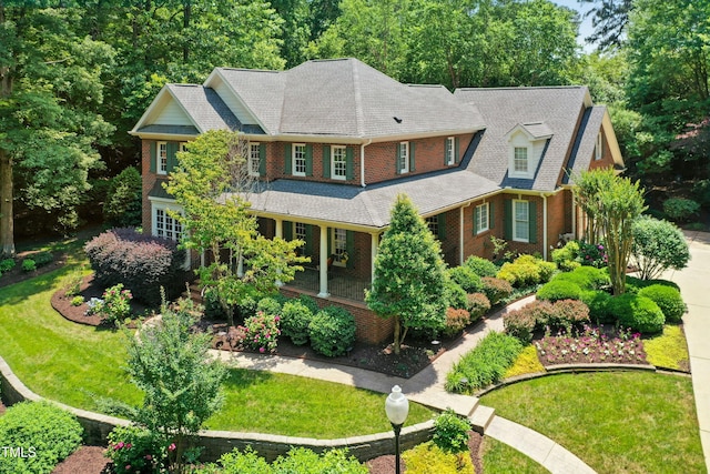 4021 Chaumont Dr, Apex, NC 27539 - view of front of property with brick siding, a front yard, and covered porch