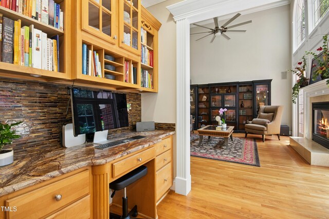 4021 Chaumont Dr, Apex, NC 27539 - home office featuring a glass covered fireplace, light wood finished floors, a ceiling fan, and ornamental molding