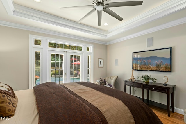 4021 Chaumont Dr, Apex, NC 27539 - bedroom with french doors, a tray ceiling, access to outside, ornamental molding, and light wood-style floors