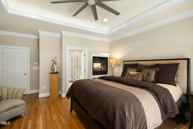 4021 Chaumont Dr, Apex, NC 27539 - bedroom with a raised ceiling, wood finished floors, crown molding, baseboards, and ceiling fan