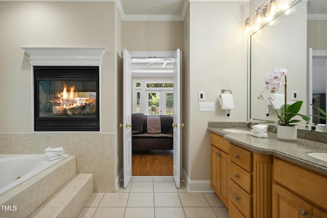 4021 Chaumont Dr, Apex, NC 27539 - ensuite bathroom with crown molding, double vanity, tile patterned flooring, a bath, and a glass covered fireplace